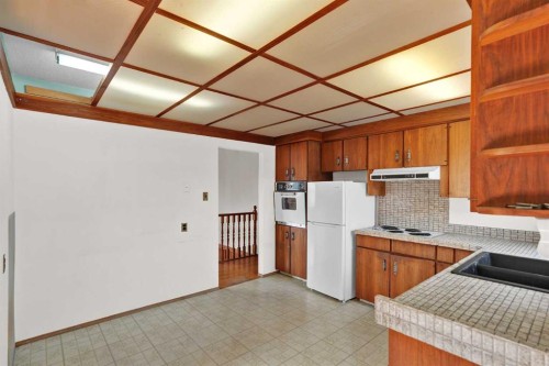 9743 Academy Drive Se, Calgary, AB - Indoor Photo Showing Kitchen With Double Sink