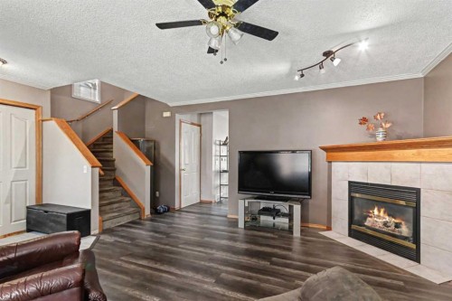 311 Erin Circle Se, Calgary, AB - Indoor Photo Showing Living Room With Fireplace