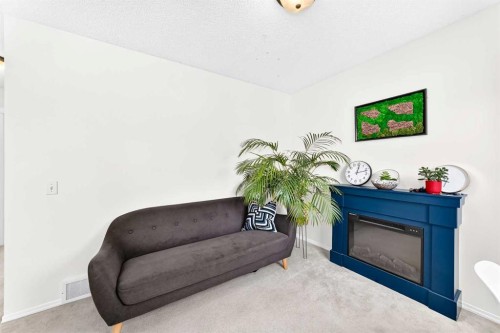 53 Tuscany Springs Heights Nw, Calgary, AB - Indoor Photo Showing Living Room With Fireplace