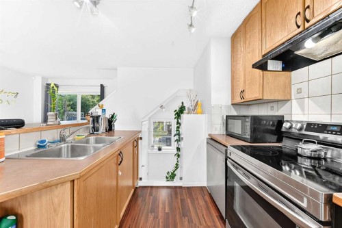 53 Tuscany Springs Heights Nw, Calgary, AB - Indoor Photo Showing Kitchen With Double Sink