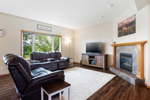 16 Henderson Bay Ne, Langdon, AB - Indoor Photo Showing Living Room With Fireplace