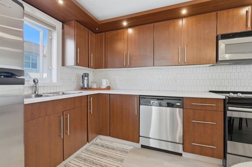 128 West Springs Road Sw, Calgary, AB - Indoor Photo Showing Kitchen With Stainless Steel Kitchen With Double Sink