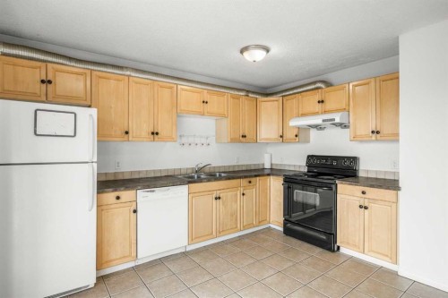 1 Edgewood Drive Nw, Calgary, AB - Indoor Photo Showing Kitchen With Double Sink