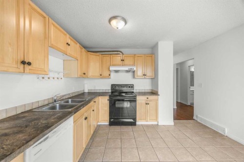 1 Edgewood Drive Nw, Calgary, AB - Indoor Photo Showing Kitchen With Double Sink