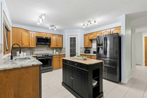 14125 Evergreen Street Sw, Calgary, AB - Indoor Photo Showing Kitchen With Stainless Steel Kitchen With Double Sink