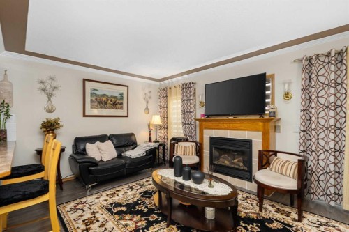 160 Millview Green Sw, Calgary, AB - Indoor Photo Showing Living Room With Fireplace