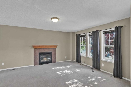 706 Everridge Drive Sw, Calgary, AB - Indoor Photo Showing Living Room With Fireplace