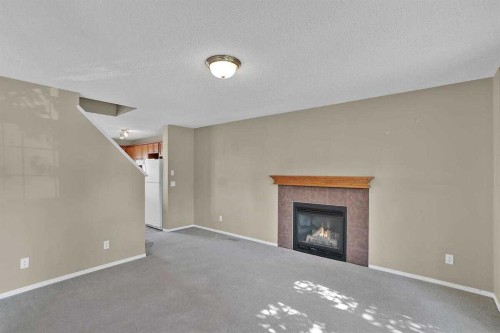 706 Everridge Drive Sw, Calgary, AB - Indoor Photo Showing Living Room With Fireplace