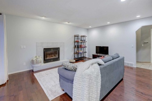 215 Arbour Ridge Way Nw, Calgary, AB - Indoor Photo Showing Living Room With Fireplace