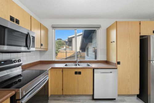 731 Queensland Drive Se, Calgary, AB - Indoor Photo Showing Kitchen With Stainless Steel Kitchen With Double Sink