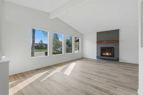 731 Queensland Drive Se, Calgary, AB - Indoor Photo Showing Living Room With Fireplace