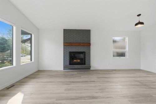 731 Queensland Drive Se, Calgary, AB - Indoor Photo Showing Living Room With Fireplace