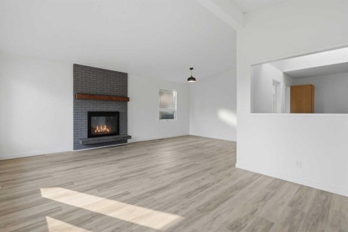 731 Queensland Drive Se, Calgary, AB - Indoor Photo Showing Living Room With Fireplace