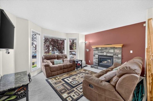 155 Tarington Green Ne, Calgary, AB - Indoor Photo Showing Living Room With Fireplace