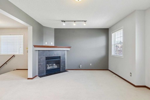 172 Kincora Drive Nw, Calgary, AB - Indoor Photo Showing Other Room With Fireplace