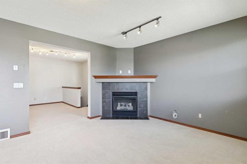 172 Kincora Drive Nw, Calgary, AB - Indoor Photo Showing Other Room With Fireplace