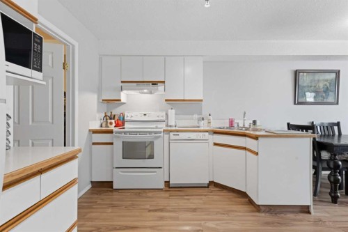208-105 7 Avenue Se, High River, AB - Indoor Photo Showing Kitchen With Double Sink
