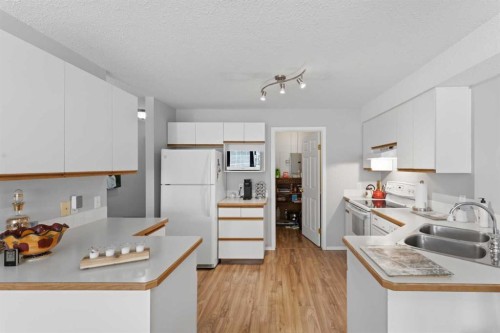 208-105 7 Avenue Se, High River, AB - Indoor Photo Showing Kitchen With Double Sink