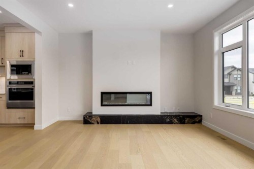 15 Alpine Green Sw, Calgary, AB - Indoor Photo Showing Living Room With Fireplace