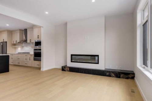 15 Alpine Green Sw, Calgary, AB - Indoor With Fireplace