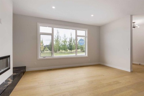 15 Alpine Green Sw, Calgary, AB - Indoor Photo Showing Other Room With Fireplace