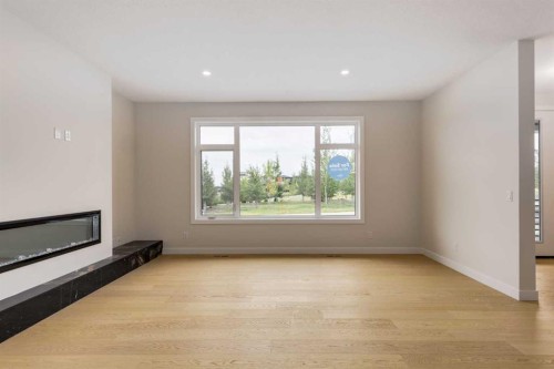 15 Alpine Green Sw, Calgary, AB - Indoor With Fireplace