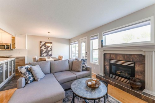 82 West Springs Way Sw, Calgary, AB - Indoor Photo Showing Living Room With Fireplace