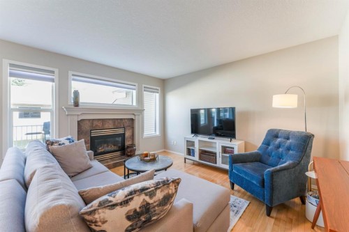 82 West Springs Way Sw, Calgary, AB - Indoor Photo Showing Living Room With Fireplace