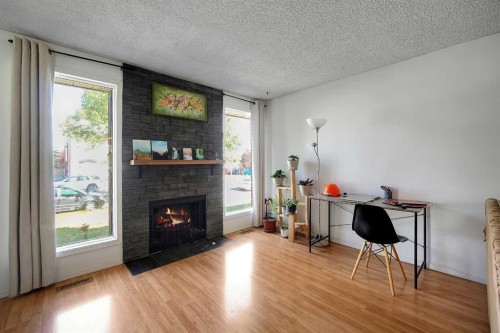 6507 Rundlehorn Drive Ne, Calgary, AB - Indoor Photo Showing Living Room With Fireplace