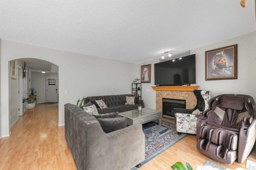 210 Taracove Landing Ne, Calgary, AB - Indoor Photo Showing Living Room With Fireplace