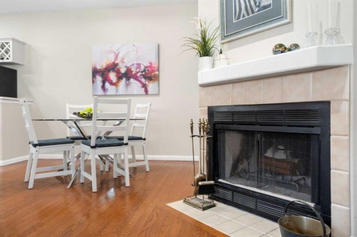 101-1997 Sirocco Drive Sw, Calgary, AB - Indoor Photo Showing Living Room With Fireplace