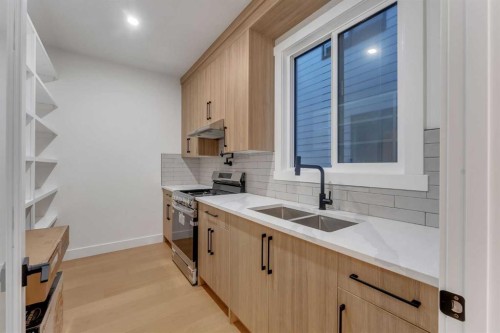 135 South Shore Road, Chestermere, AB - Indoor Photo Showing Kitchen With Double Sink
