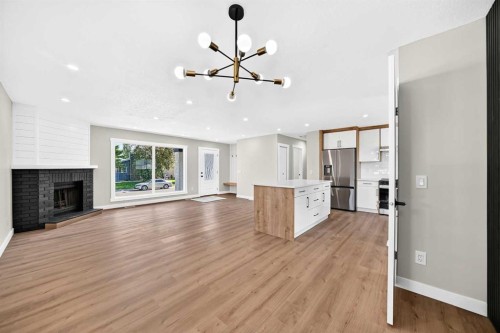 704 Malvern Drive Ne, Calgary, AB - Indoor Photo Showing Living Room With Fireplace