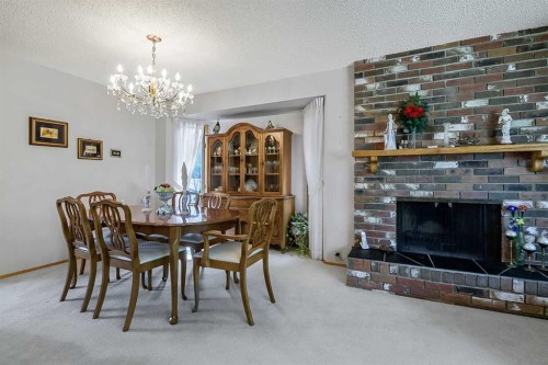832 Canna Crescent Sw, Calgary, AB - Indoor Photo Showing Dining Room With Fireplace
