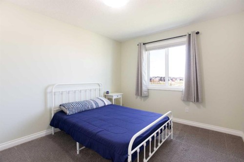 87 Baywater Rise Sw, Airdrie, AB - Indoor Photo Showing Bedroom