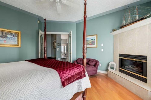 1001 East Chestermere Drive, Chestermere, AB - Indoor Photo Showing Bedroom With Fireplace