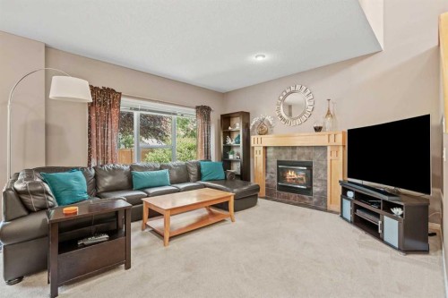 52 Copperfield Close Se, Calgary, AB - Indoor Photo Showing Living Room With Fireplace