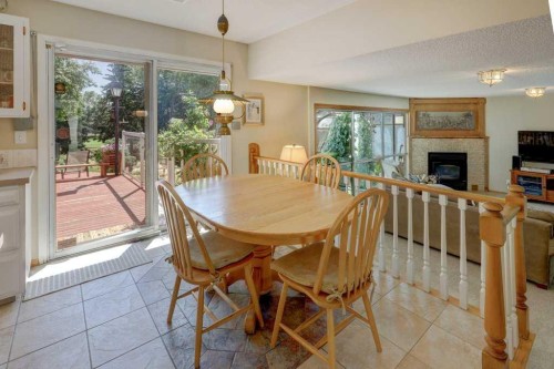 223 Willow Ridge Place Se, Calgary, AB - Indoor Photo Showing Dining Room With Fireplace