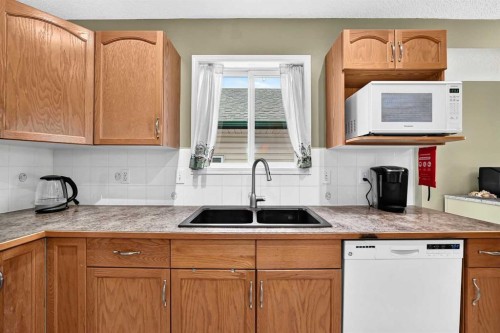 27 Erin Meadow Crescent Se, Calgary, AB - Indoor Photo Showing Kitchen With Double Sink