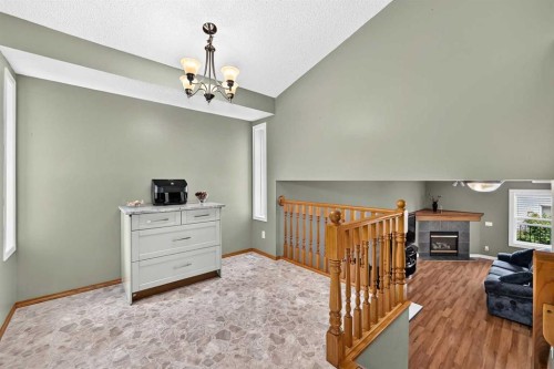 27 Erin Meadow Crescent Se, Calgary, AB - Indoor Photo Showing Other Room With Fireplace
