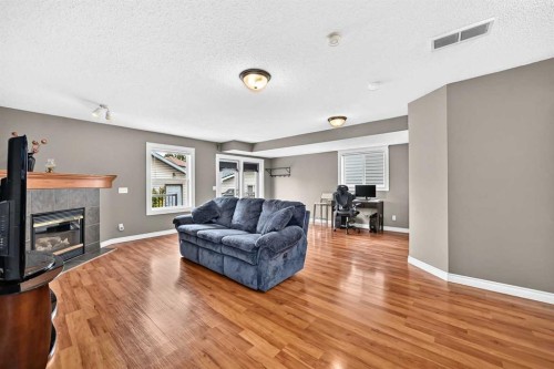 27 Erin Meadow Crescent Se, Calgary, AB - Indoor Photo Showing Living Room With Fireplace