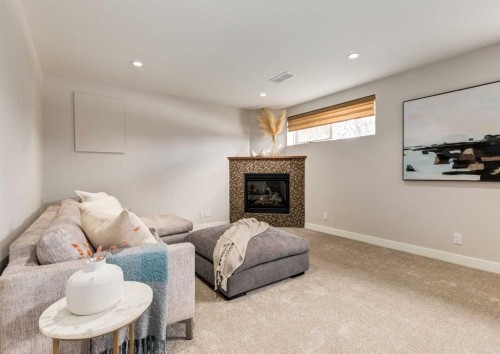 176 Mapleburn Drive Se, Calgary, AB - Indoor Photo Showing Living Room With Fireplace