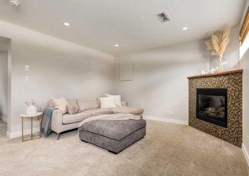 176 Mapleburn Drive Se, Calgary, AB - Indoor Photo Showing Living Room With Fireplace