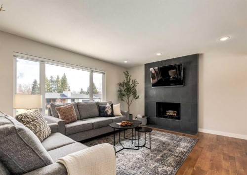 176 Mapleburn Drive Se, Calgary, AB - Indoor Photo Showing Living Room With Fireplace