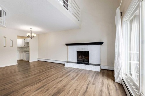 303-730 2 Avenue Nw, Calgary, AB - Indoor Photo Showing Living Room With Fireplace