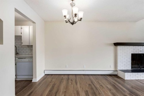 303-730 2 Avenue Nw, Calgary, AB - Indoor Photo Showing Other Room With Fireplace