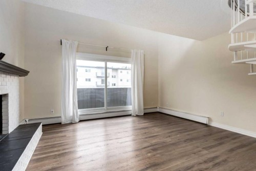 303-730 2 Avenue Nw, Calgary, AB - Indoor With Fireplace
