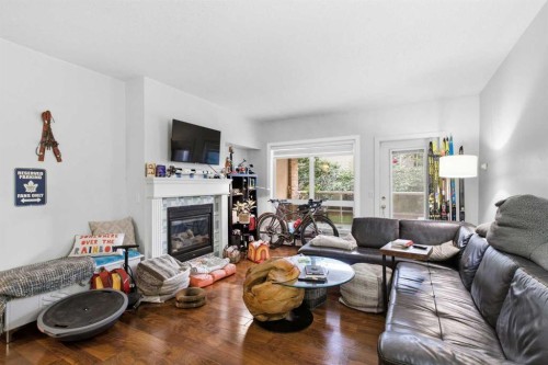 108-114 15 Avenue Sw, Calgary, AB - Indoor Photo Showing Living Room With Fireplace