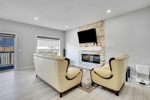 50 Saddlestone Place Ne, Calgary, AB - Indoor Photo Showing Other Room With Fireplace