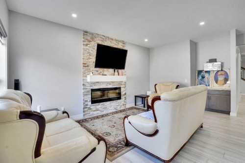 50 Saddlestone Place Ne, Calgary, AB - Indoor Photo Showing Living Room With Fireplace